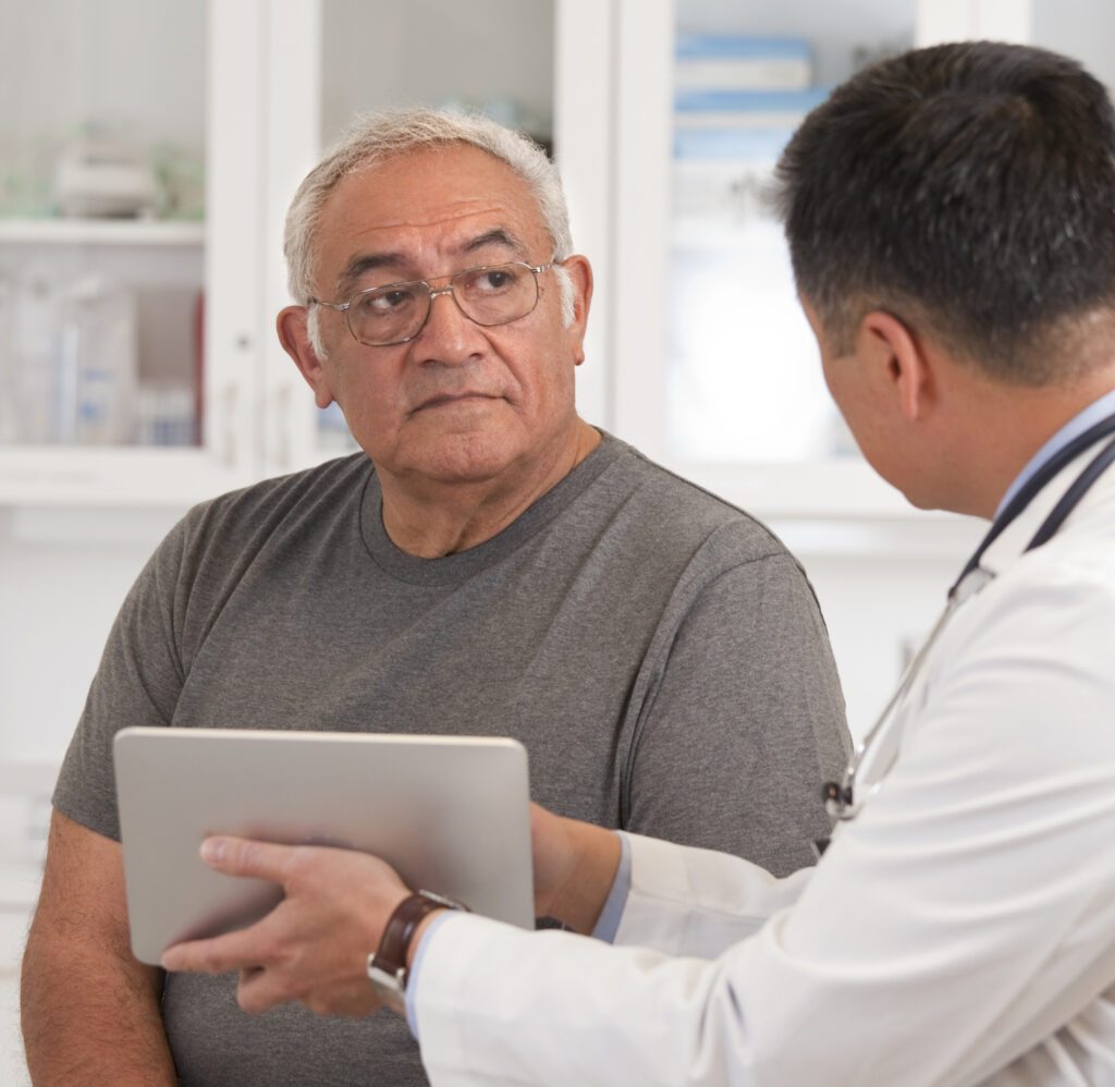 older man being consulted by doctor